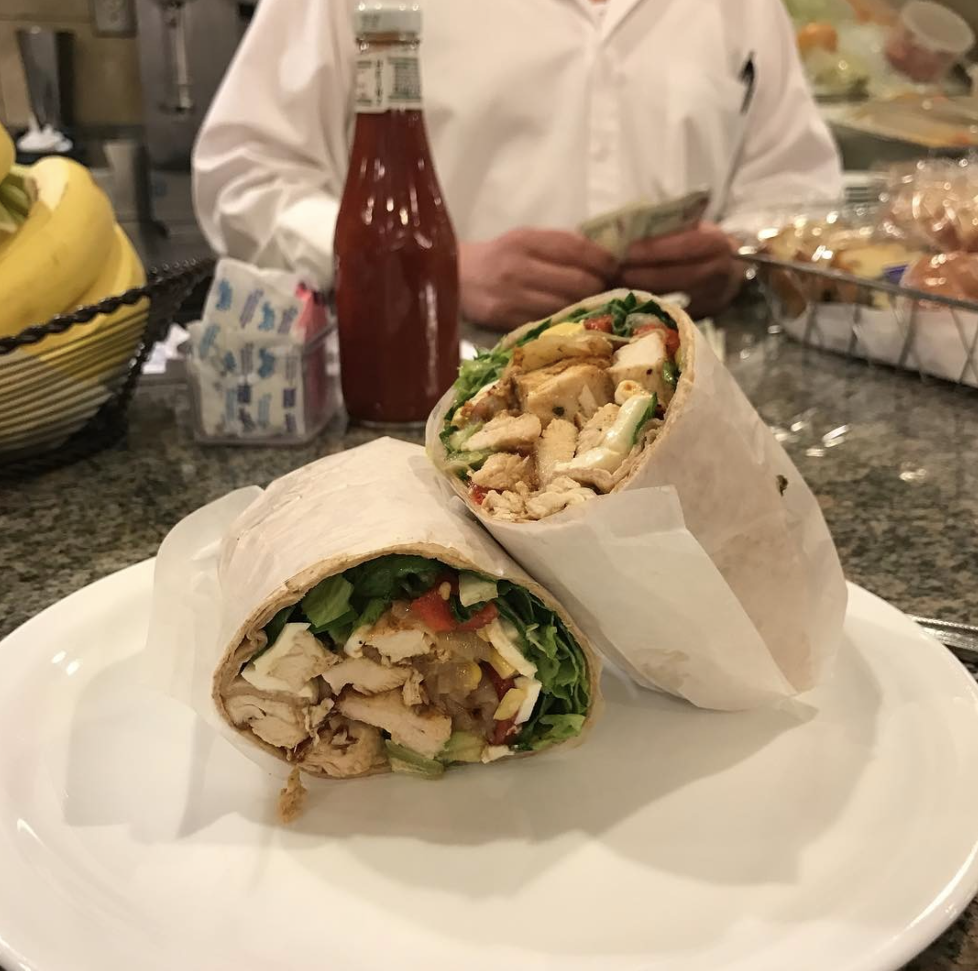 Chicken wrap cut in half at the Three Guys counter.