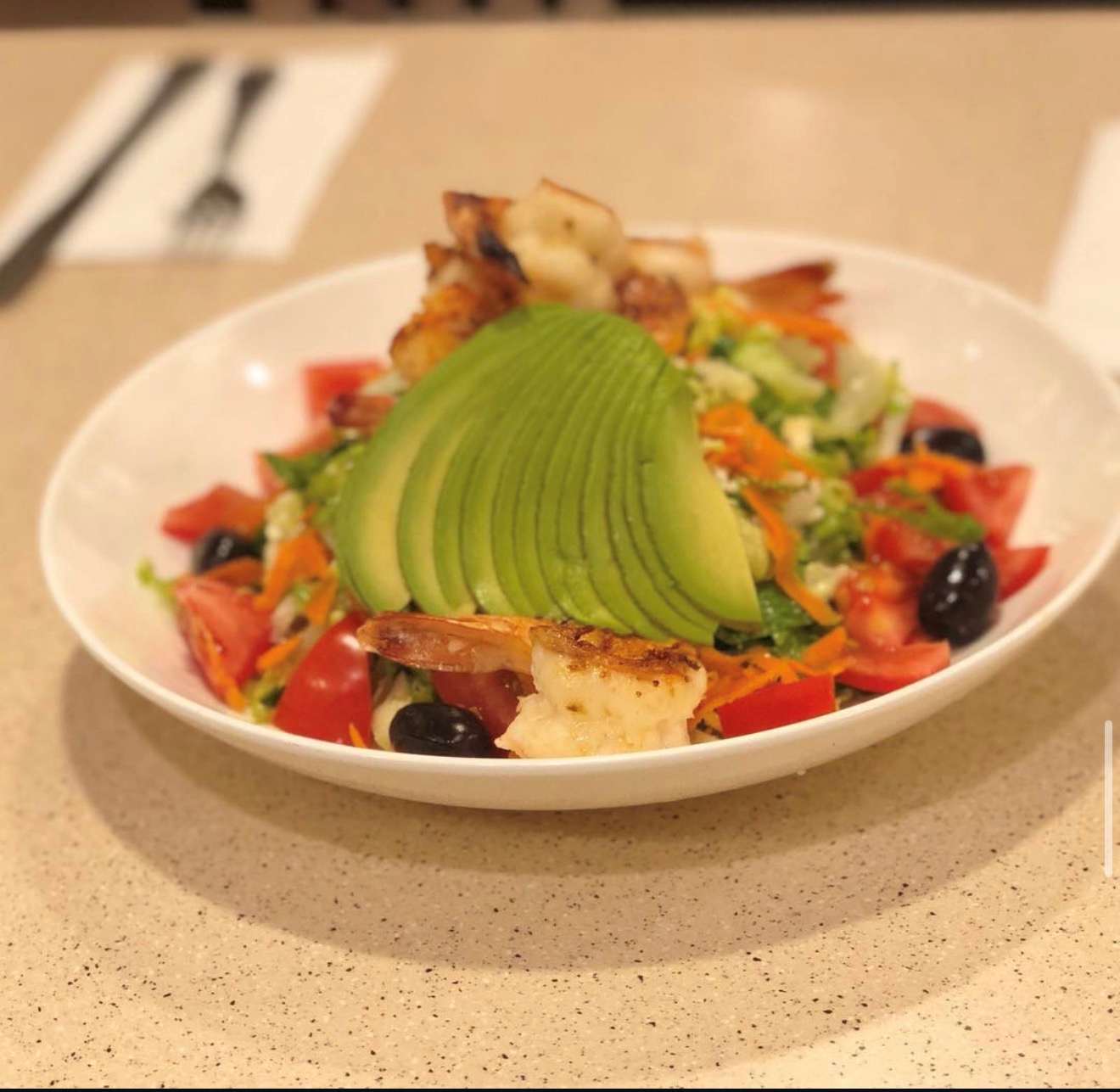 Avocado and grilled shrimp salad served at Three Guys.
