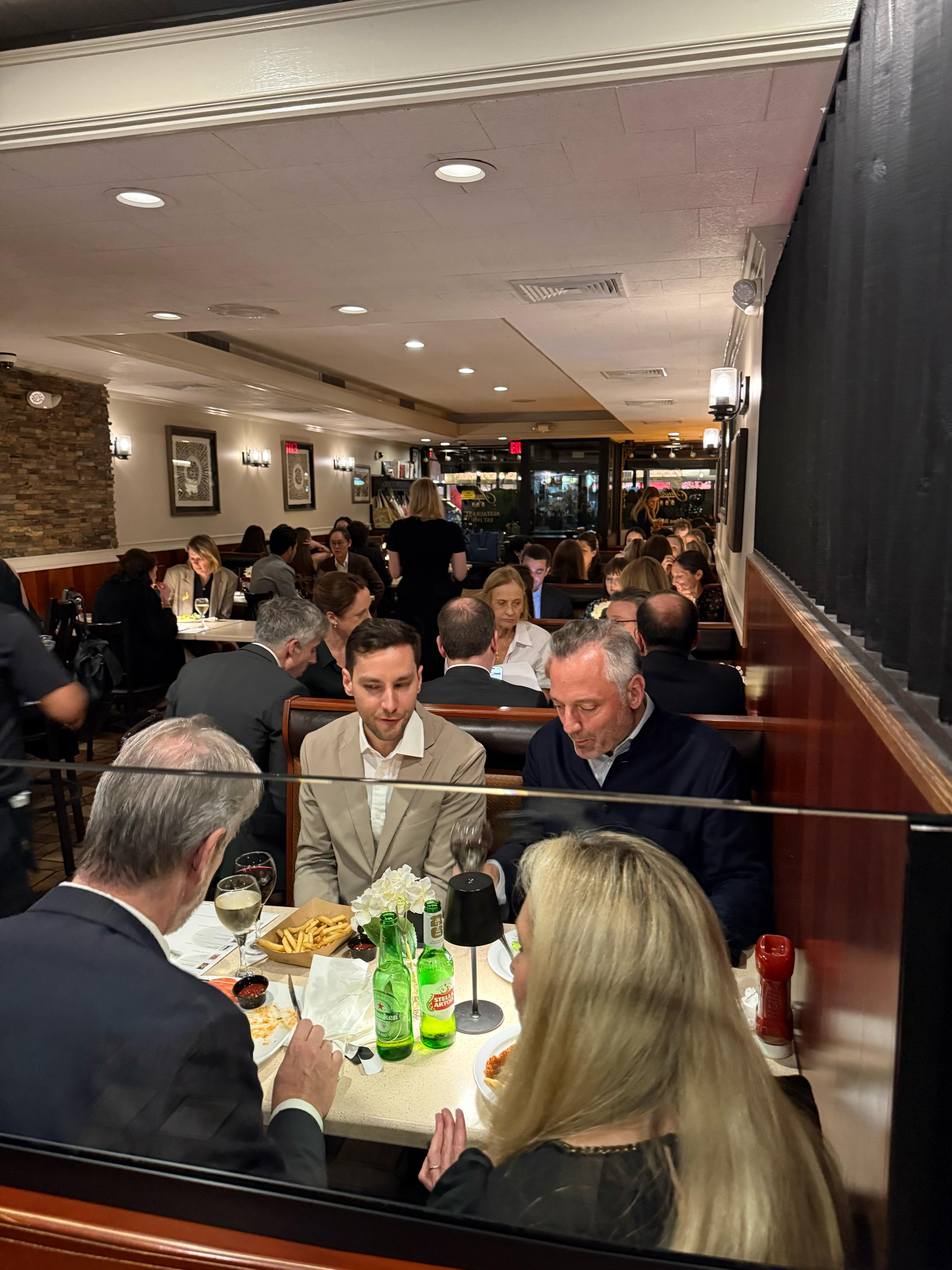 Three Guys dining room full during service with regulars seated in the booths.