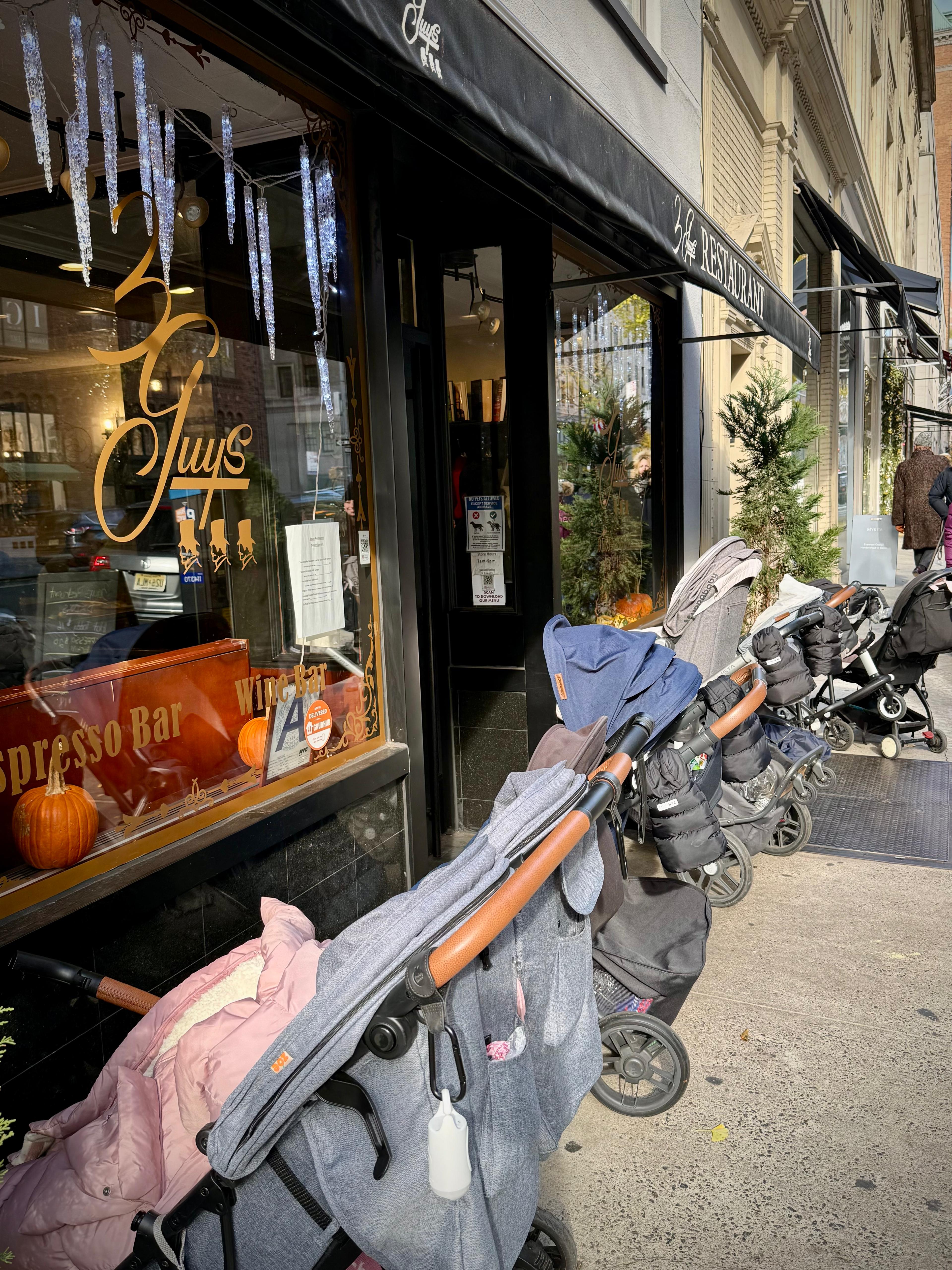 Strollers lined up outside Three Guys on Madison Avenue.